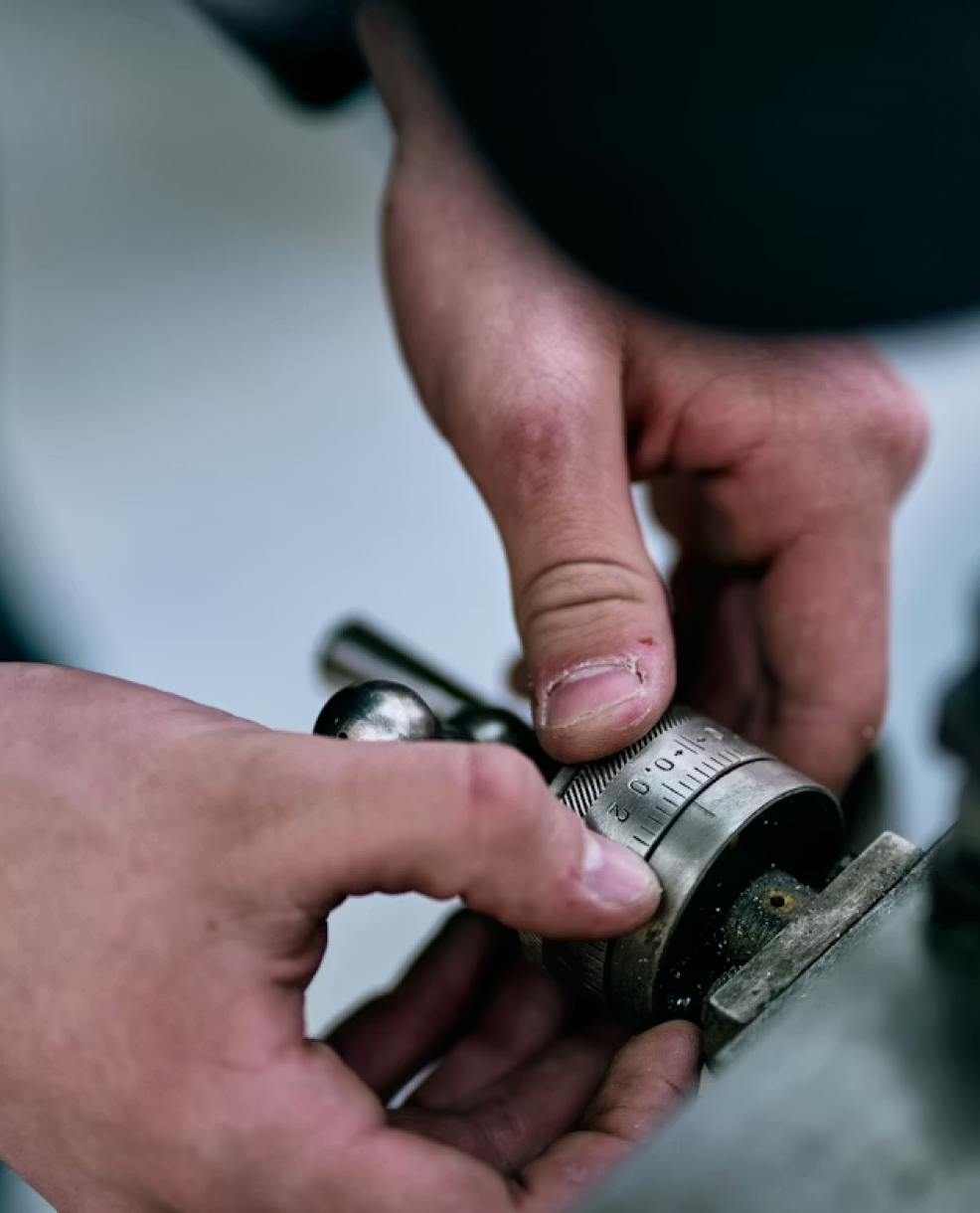 Close-up of hands holding a hand tool